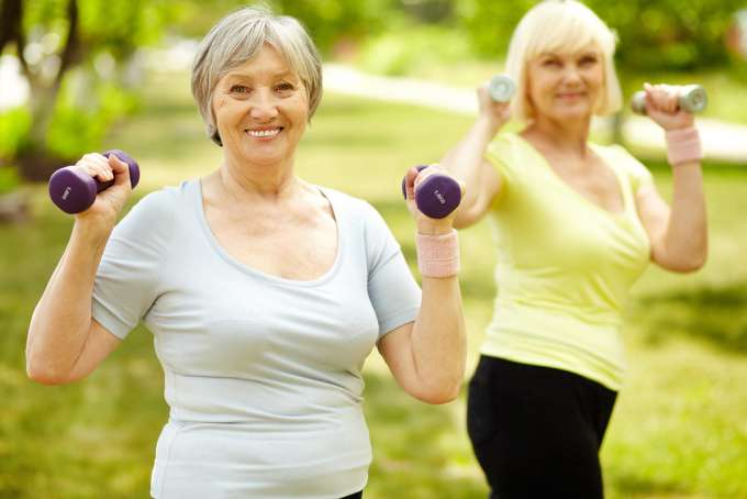 Older women exercising with free weights