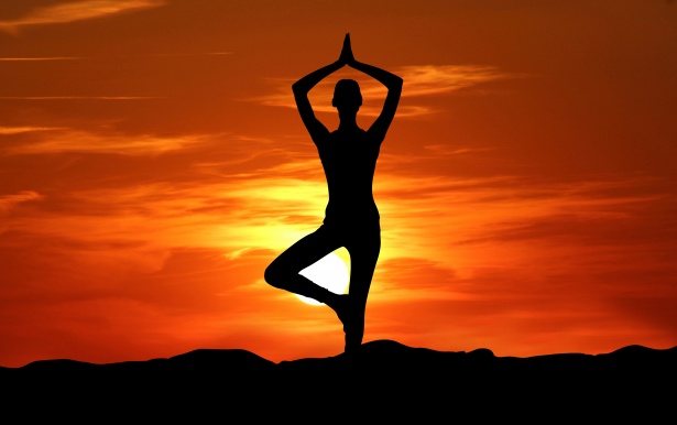 Silhouette of a person doing toga at sunset